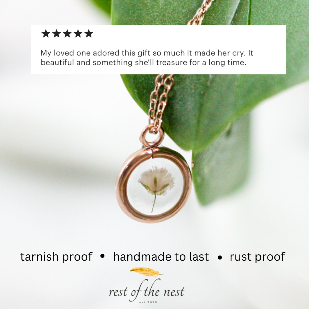 rose gold necklace with a piece of babys breath and a 5 star review