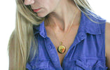 woman wearing gold locket closed