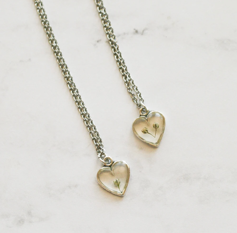 two necklaces with 1 and 2 pieces of babys breath in silver heart pendant