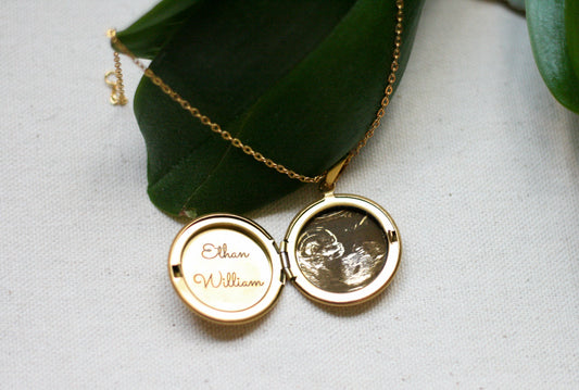 gold locket with sonogram and baby name engraved inside