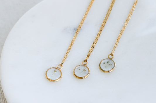 three babys breath necklaces with 1,2 and 3 pieces of babys breath inside