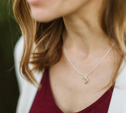 woman wearing a  silver heart babys breath necklace 