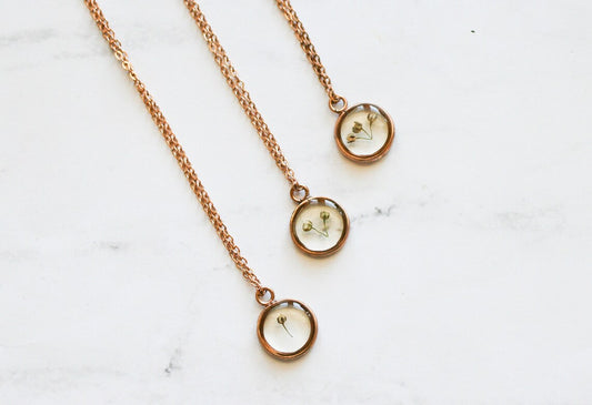 three babys breath necklaces with 1,2 and 3 pieces of babys breath in a rose gold pendant 