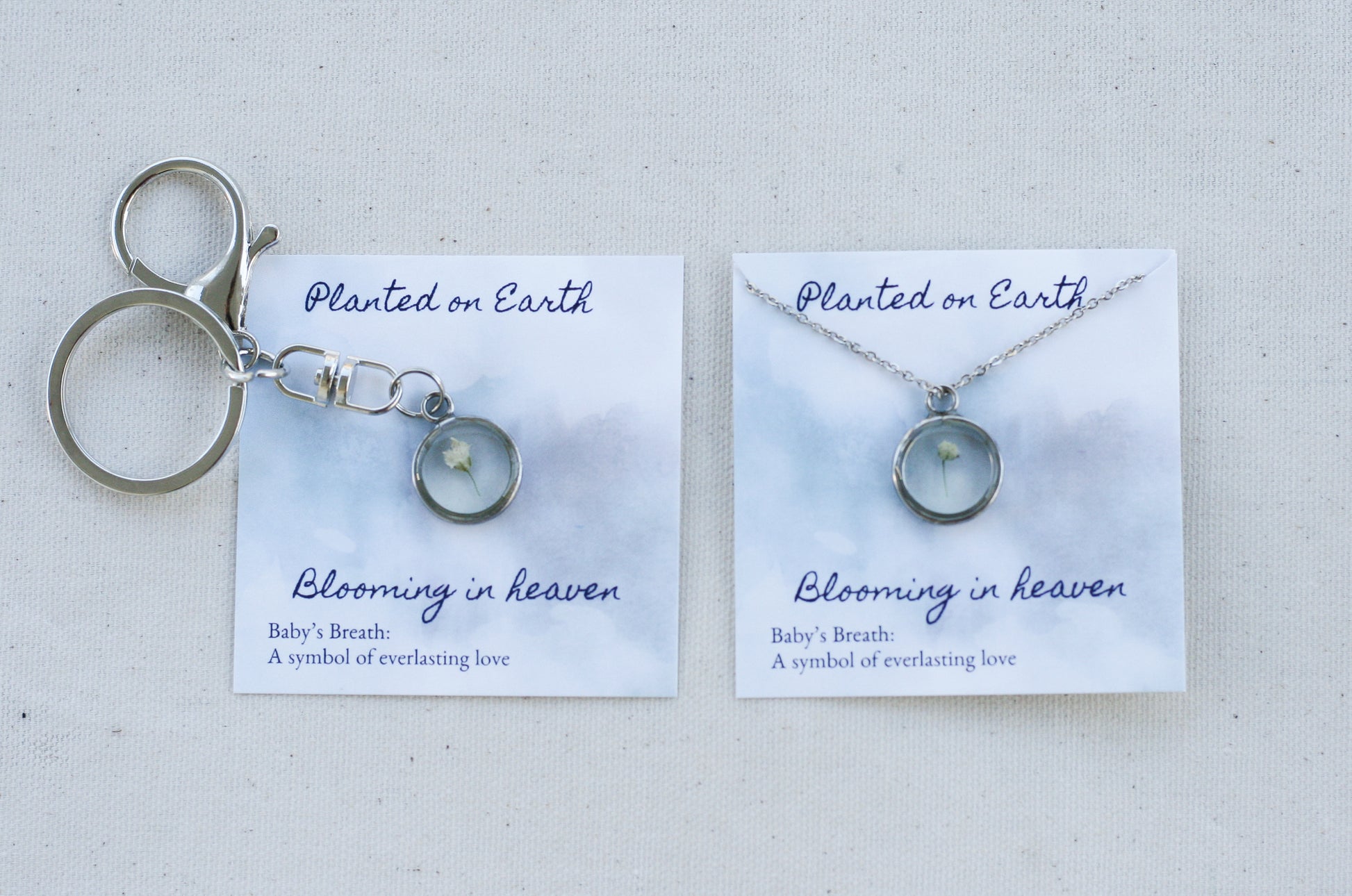 babys breath necklace and keychain in silver on "planted on earth blooming in heaven" cards