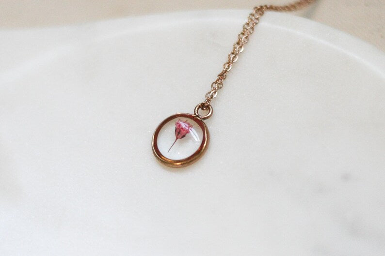 one piece of pink babys breath in a rose gold pendant necklace