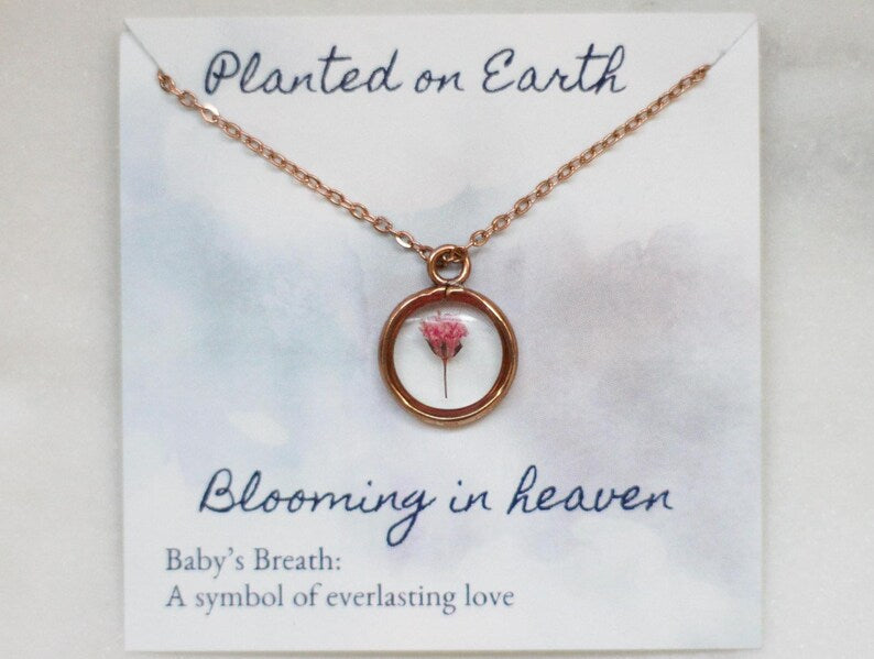 pink babys breath necklace on a card reading "planted on earth blooming in heaven"