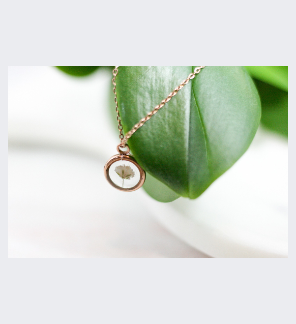 one piece of bloomed babys breath in a rose gold pendant necklace