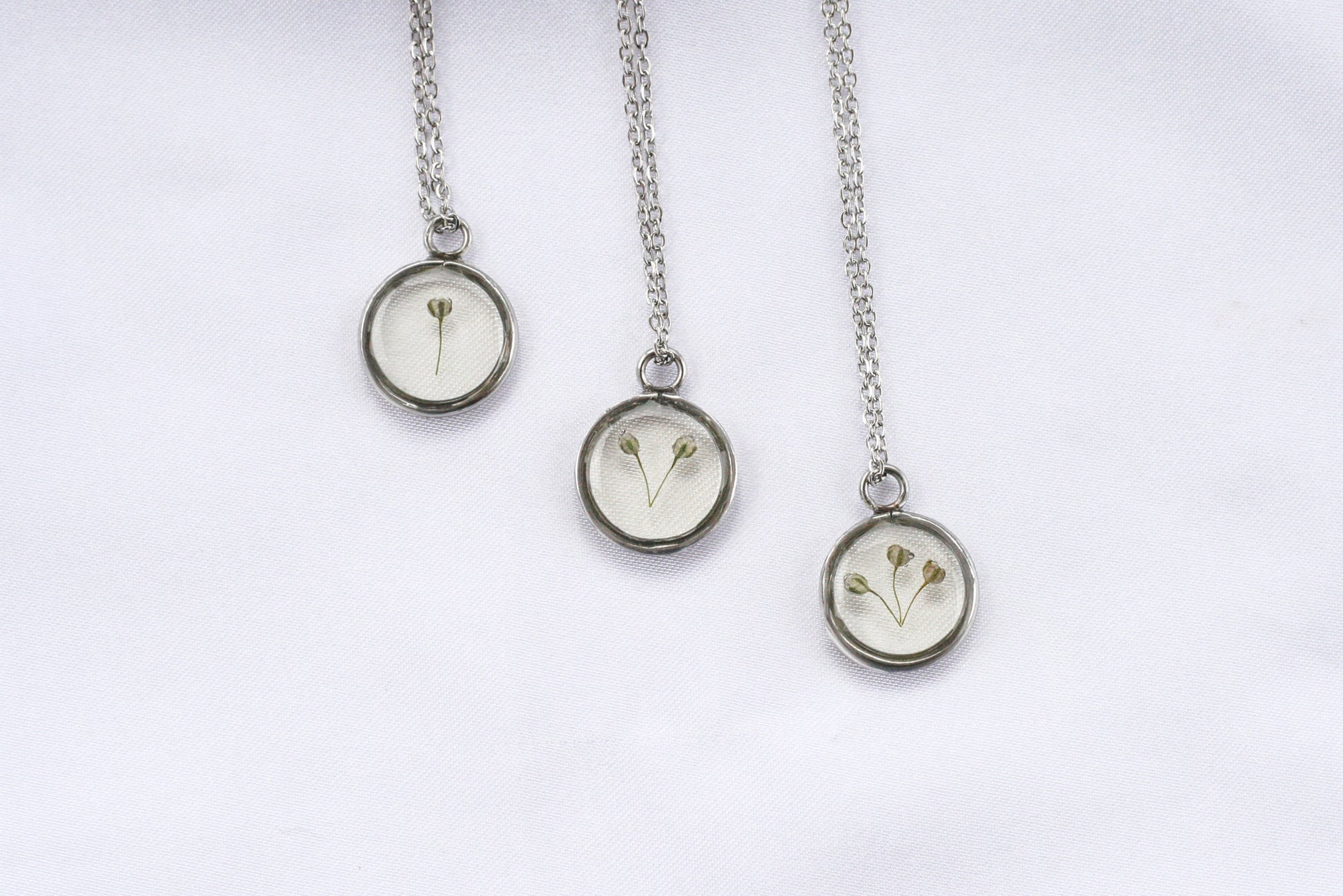 3 necklaces with 1, 2 and 3 pieces of babys breath in silver necklaces